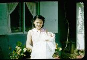 Saipan 1956, No. 0041 Baby in Baptismal Clothes Outside the House